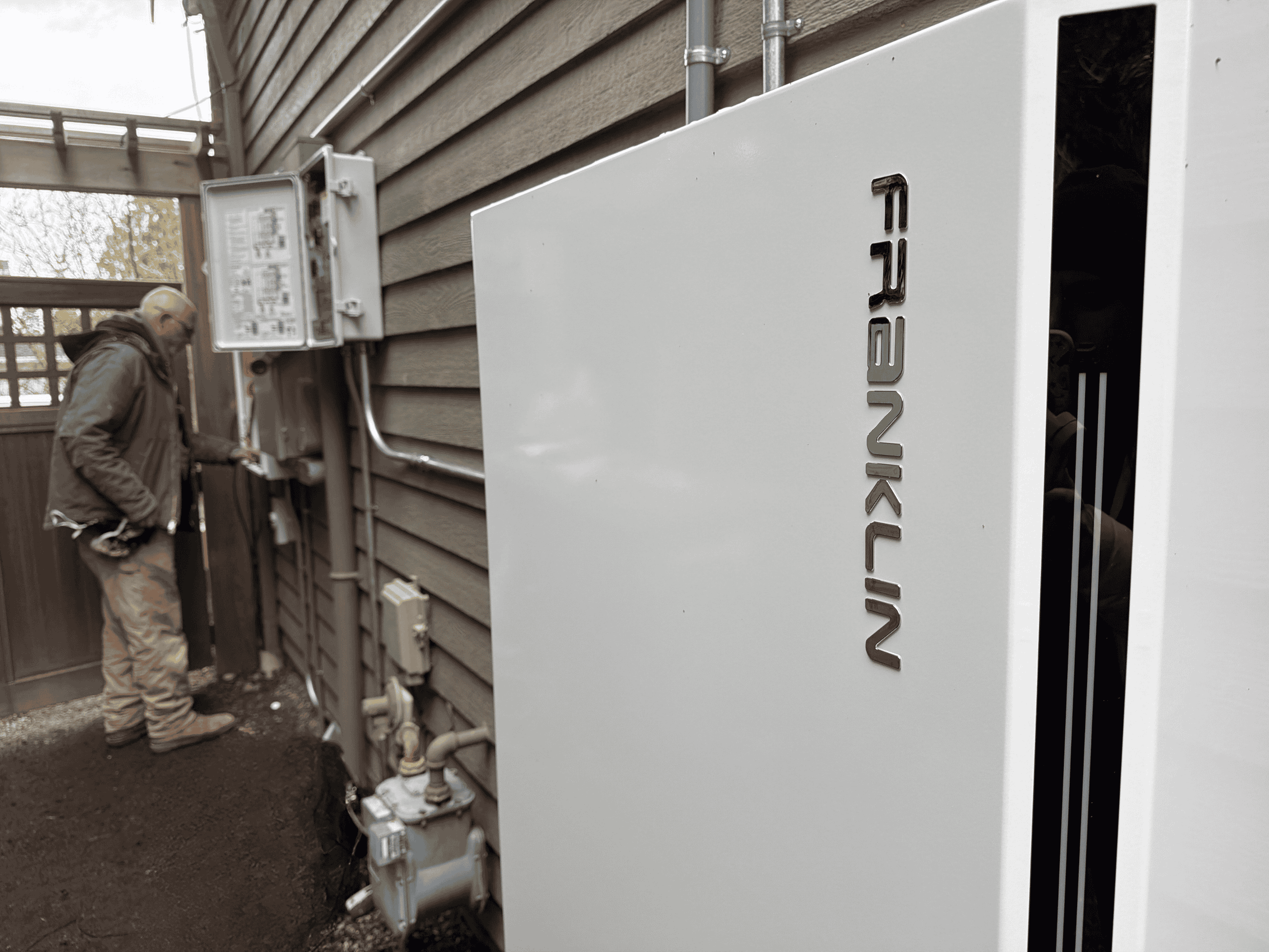 Solterra Solar journeyman electrician installing a whole-home FranklinWH aPower 2 backup battery system integrated with solar on a residential property on Mercer Island, Washington.